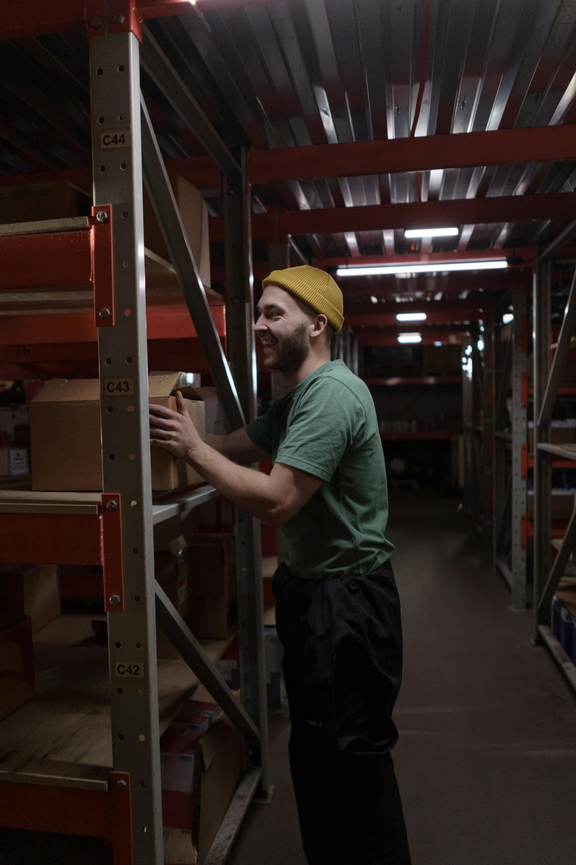 A seller pulling stock from warehouse shelving